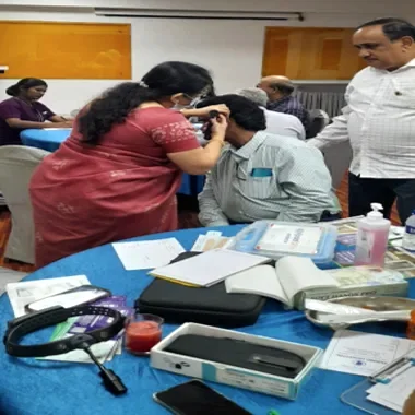 THANC doctor performing ENT screening at Lions Club health camp